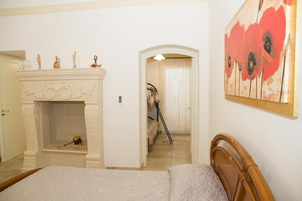 a bedroom with a fireplace and a bed in a room at Le Tenute di Agnese in Felline