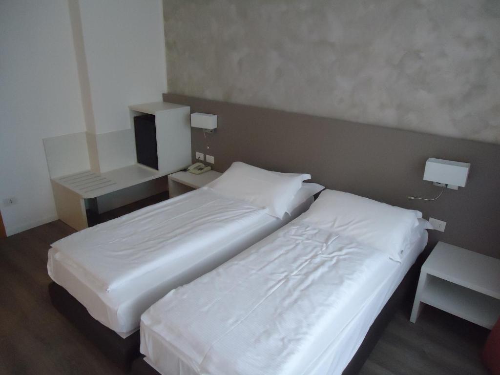 Postel nebo postele na pokoji v ubytování Hotel Piccolo Mondo