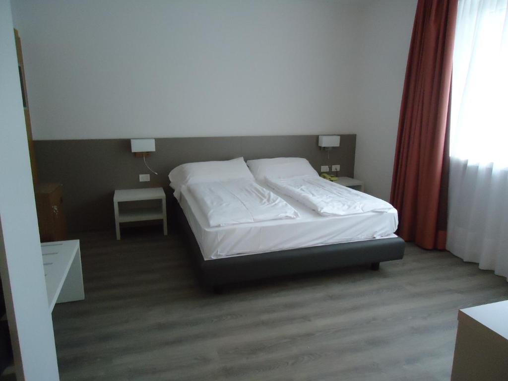 Postel nebo postele na pokoji v ubytování Hotel Piccolo Mondo