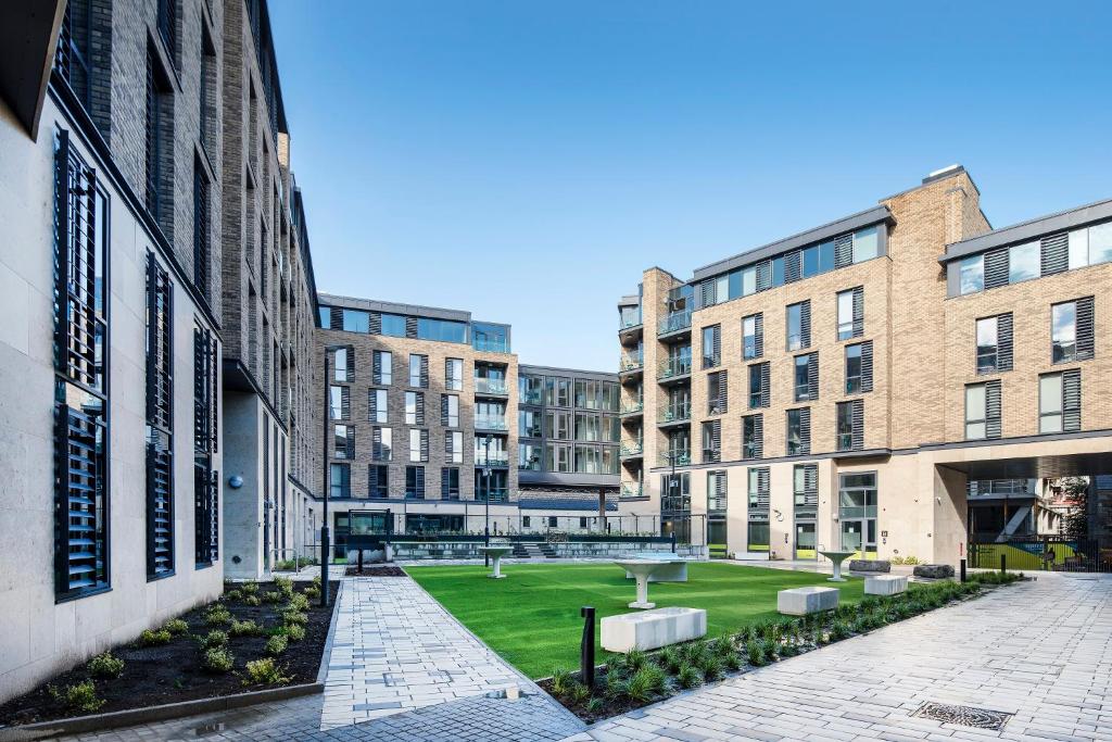 a courtyard with buildings and a park with a fountain at Destiny Student - New Mill in Dublin