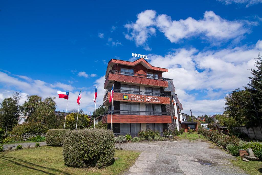 a building with a sign on top of it at Hotel Terrazas del Lago in Puerto Varas