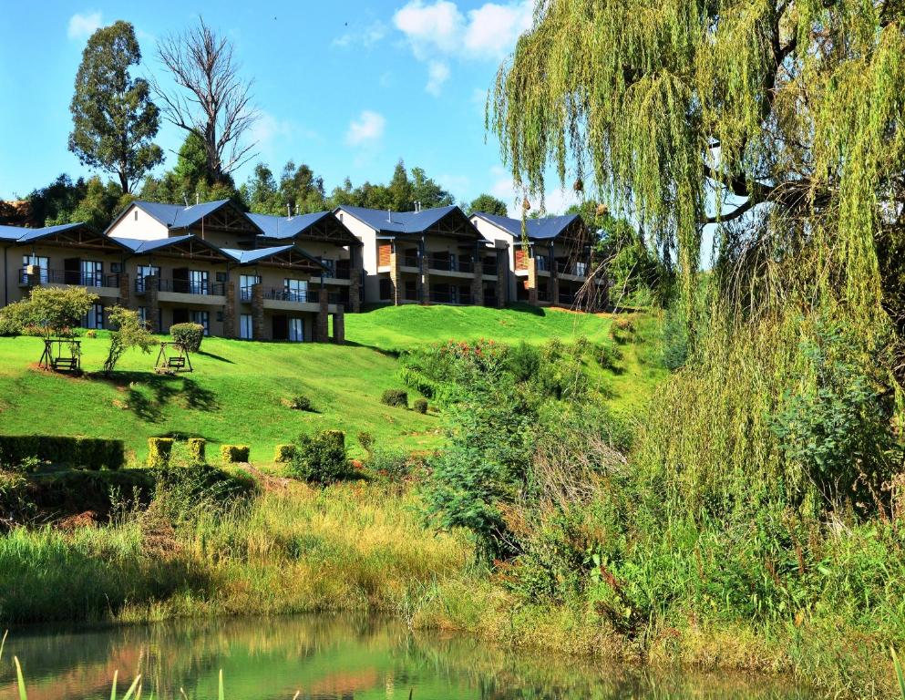 a large body of water with trees and houses at Premier Resort Sani Pass in Himeville