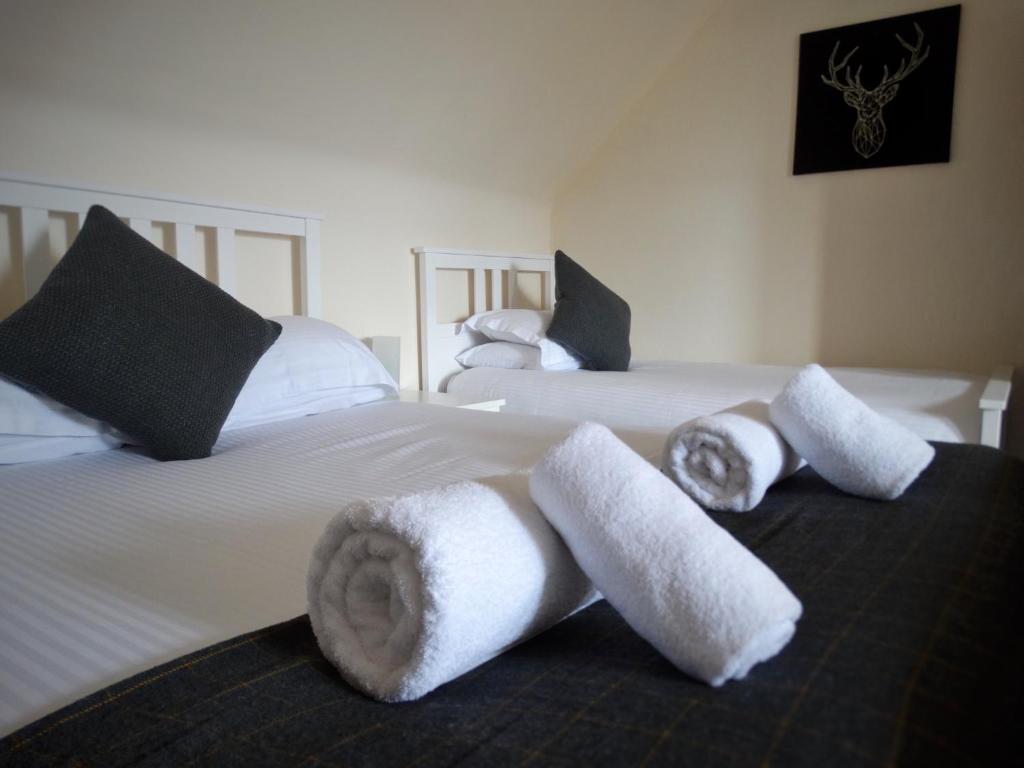 A bed or beds in a room at Kilchoan Hotel