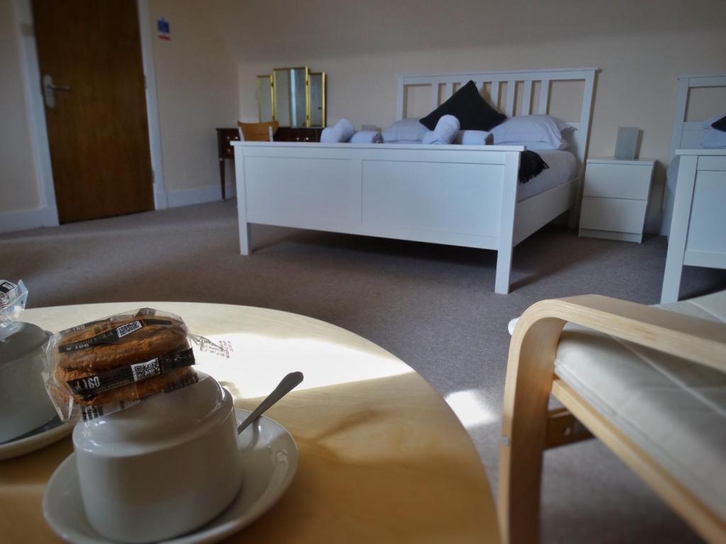 A bed or beds in a room at Kilchoan Hotel