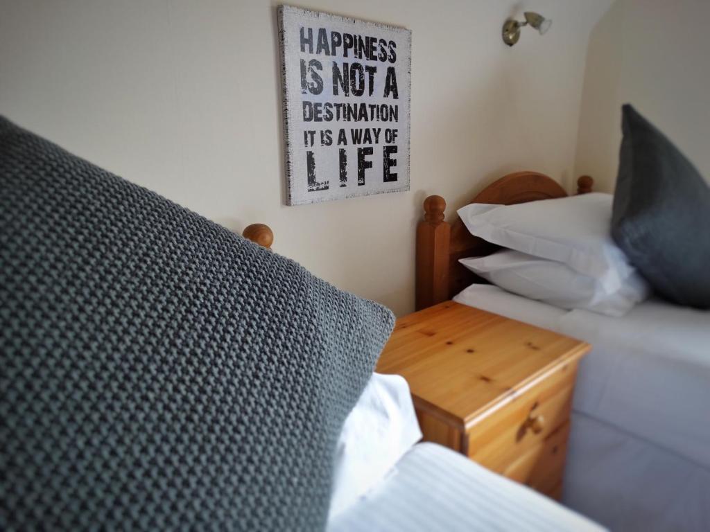 A bed or beds in a room at Kilchoan Hotel