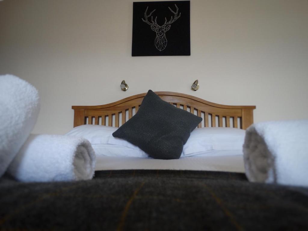 A bed or beds in a room at Kilchoan Hotel