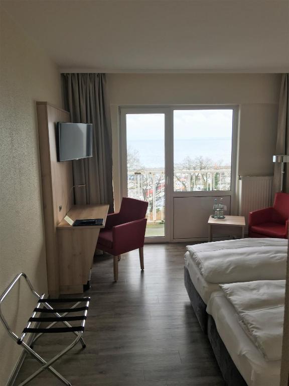 Postel nebo postele na pokoji v ubytování Rügen-Hotel