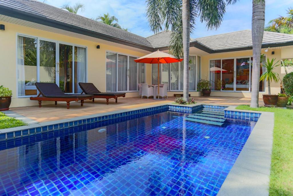 a swimming pool in front of a house at 5 Islands Beach Villa @ Lipa Noi in Lipa Noi