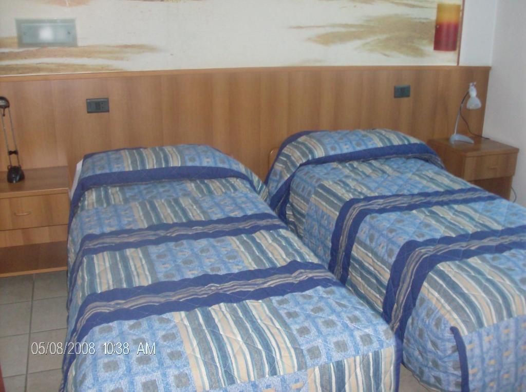 Postel nebo postele na pokoji v ubytování Borromeo Residenze Service s.a.s