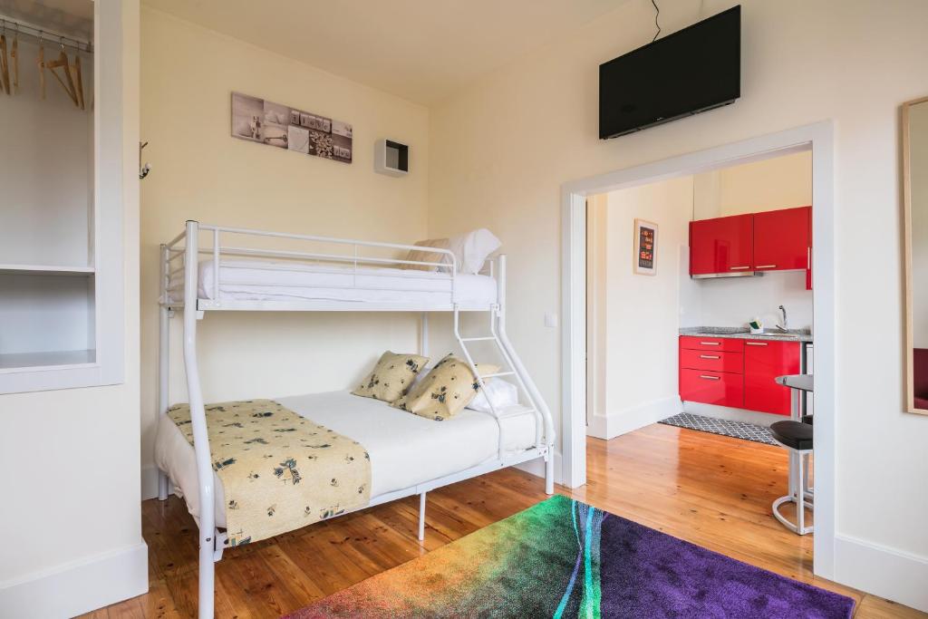 ポルトにあるÀ Francos Burguer Stationのベッドルーム1室(二段ベッド1組付)、キッチンが備わります。
