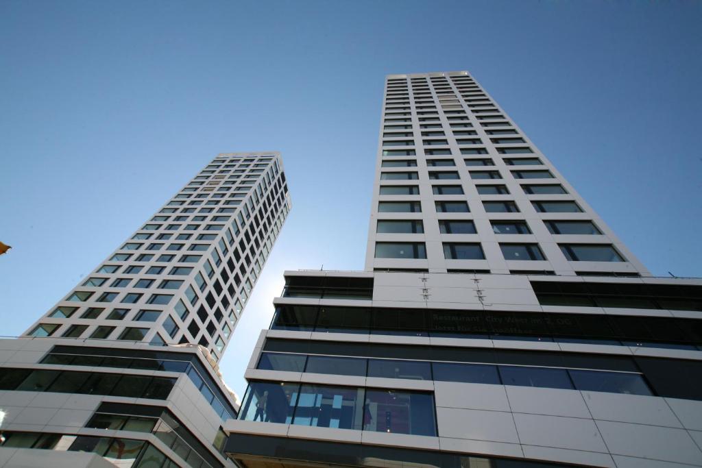 two tall skyscrapers with the sky in the background at Mercure Chur City West in Chur