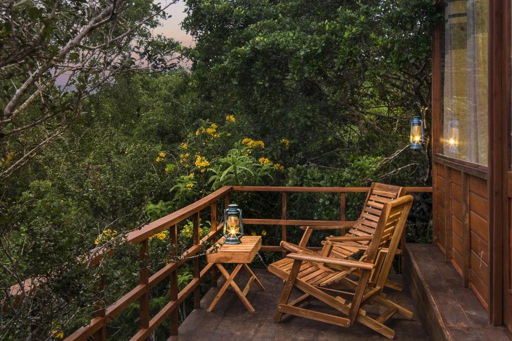 two chairs and a table on a porch at Leopard Nest - Glamping in Yala in Yala