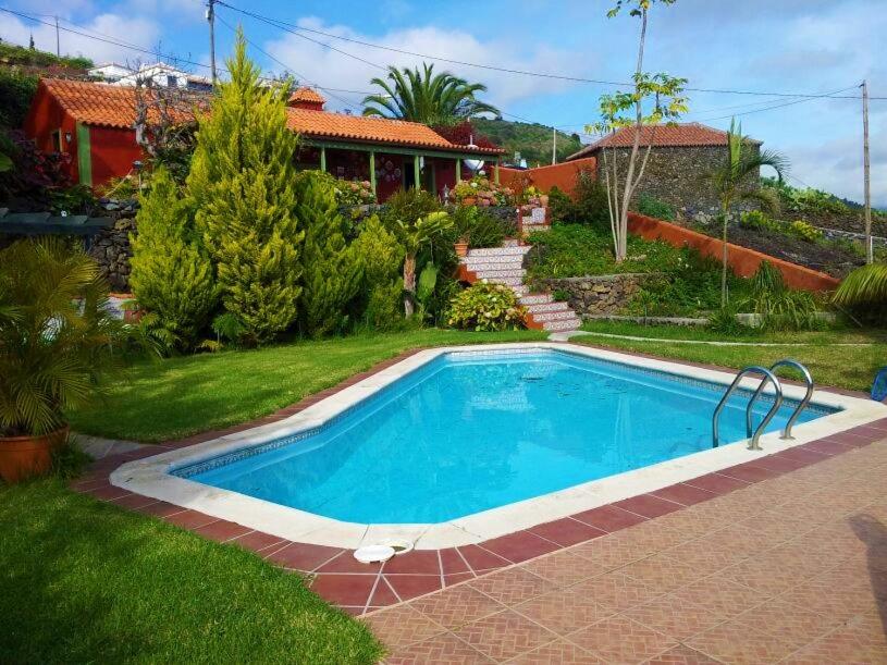 a swimming pool in the yard of a house at La casita de Mazo in Mazo