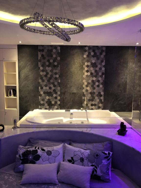 a large bath tub with three pillows in a bathroom at Assisi Luxury SPA Suite in Assisi