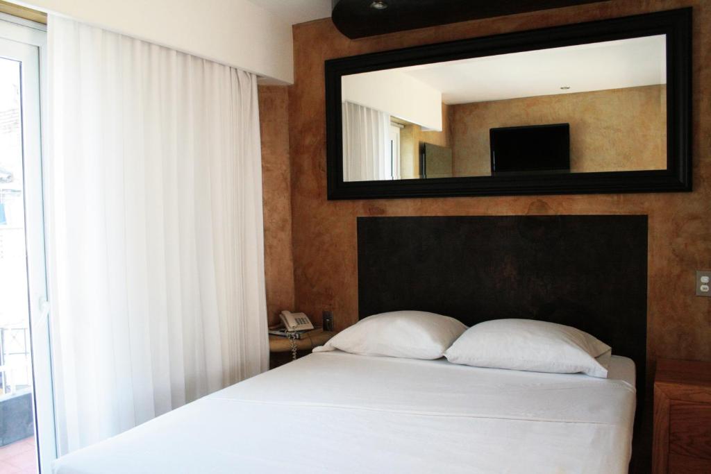 Postel nebo postele na pokoji v ubytování Hotel Rio Malecon