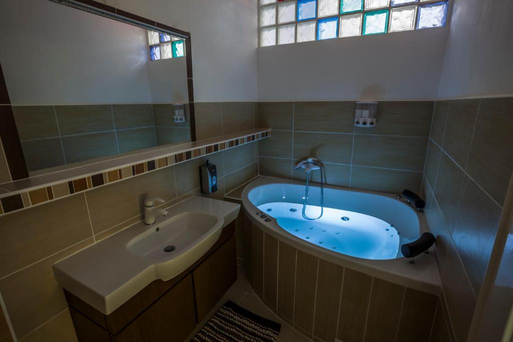 a bathroom with a tub and a sink at Luxury Air-Conditioned rooms in Old Town Bratislava in Bratislava