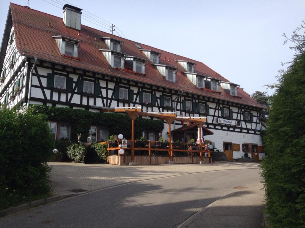 a large building with a red roof at Hotel Restaurant Mönchhof in Gaggenau