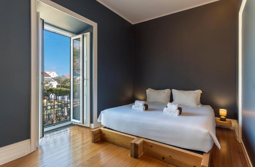 
a bedroom with a bed and a window at Out of the Blue in Ponta Delgada
