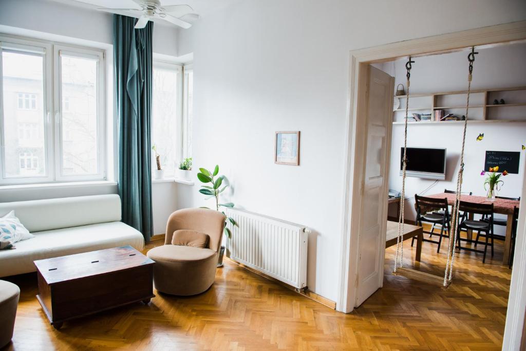 a living room with a couch and a table at Tenement Apartment 90m2 City Center in Krakow
