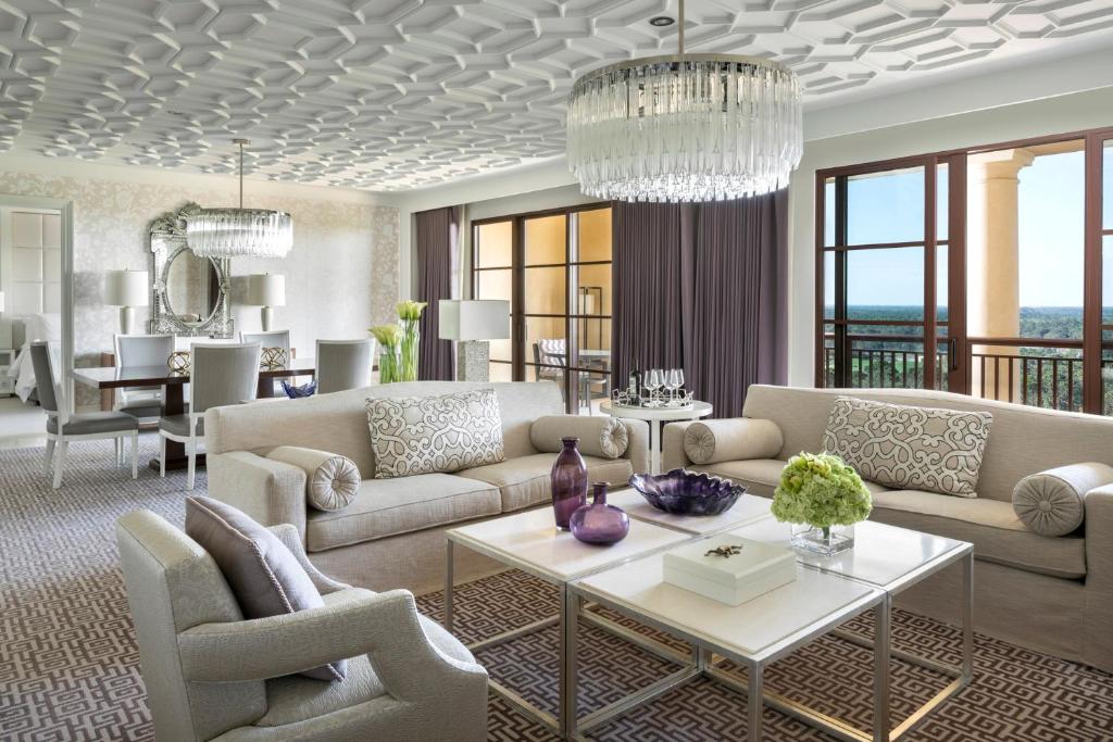 a living room with couches and a table at Four Seasons Resort Orlando at Walt Disney World Resort in Orlando