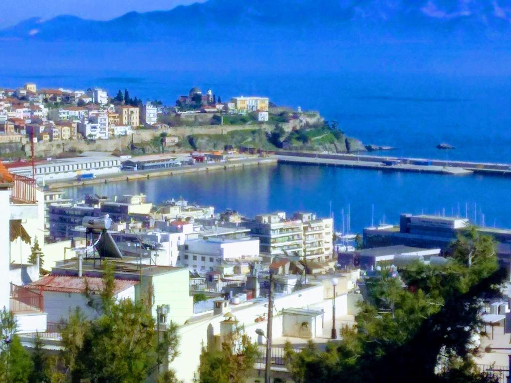 a view of a city and the ocean at Théa Apartment in Kavala