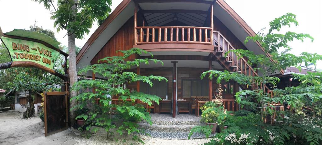 a house with a deck on the side of it at Theresa's Pension House in San Vicente