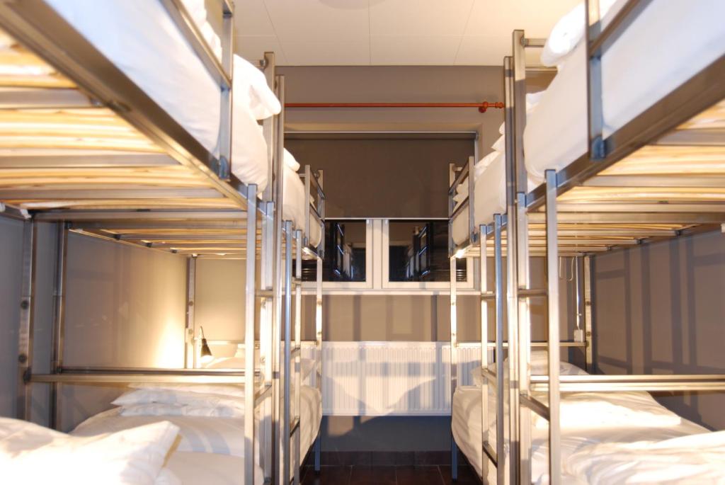 A bed or beds in a room at Tehúsið Hostel & Guesthouse