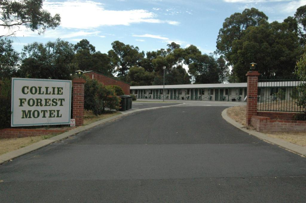 a building with a sign that reads college forest motel at Collie Forest Motel in Collie