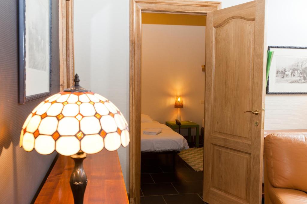 Postel nebo postele na pokoji v ubytování Aparthotel Le Manoir du Capitaine