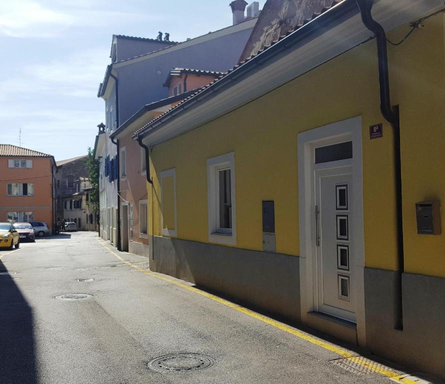 a yellow building on the side of a street at Istrian Sunrise in Koper