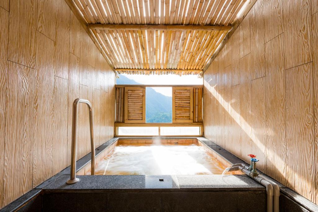 a bath tub in a room with a window at King&#39;s Resort &amp; Spa in Tai&#39;an