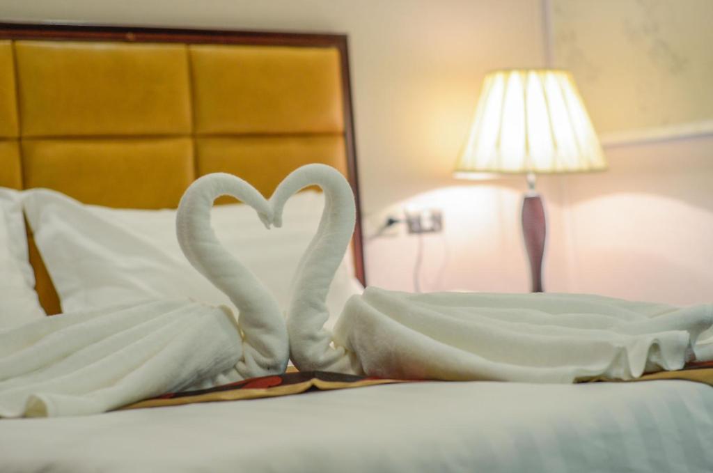 Postel nebo postele na pokoji v ubytování Palawan Uno Hotel