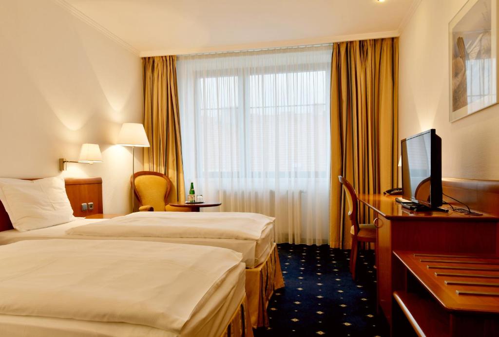 Postel nebo postele na pokoji v ubytování Hotel Coronet