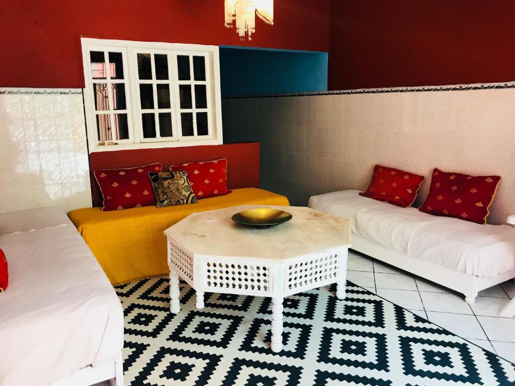 a living room with two couches and a table at Gite Le Nomade in Mirleft