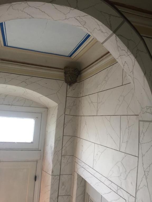 a bathroom with a window and a white marble wall at Villa Eugenia in Livorno