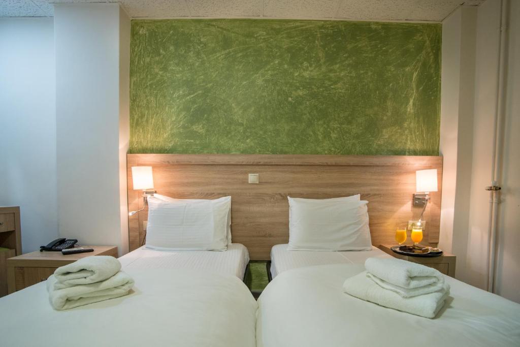 Postel nebo postele na pokoji v ubytování Anita Hotel