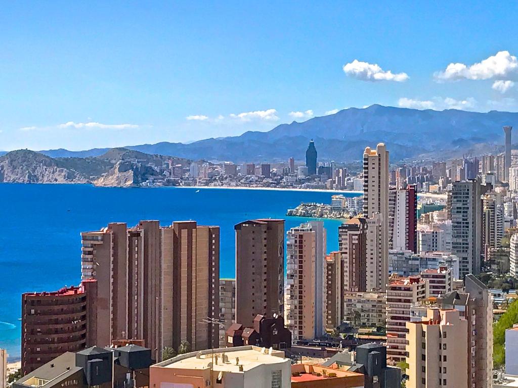 a view of a city with the ocean and buildings at Residence Vacanza Torre Monaco in Benidorm
