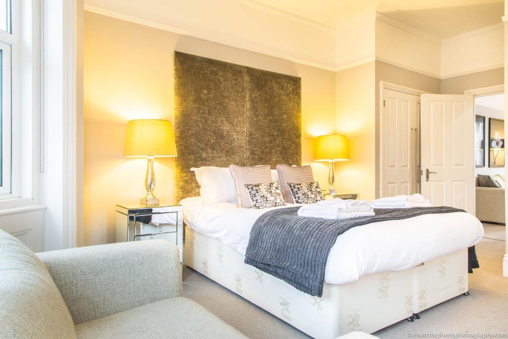 a bedroom with a bed and a couch at Alum Chine Beach House in Bournemouth