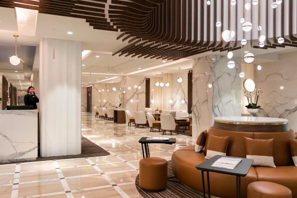 a person taking a picture of a hotel lobby at Hôtel Barrière Le Gray d'Albion in Cannes