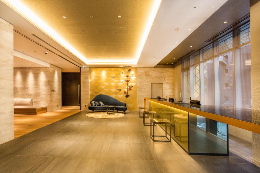 a lobby with a bar and a couch at Hotel Musse Ginza Meitetsu in Tokyo