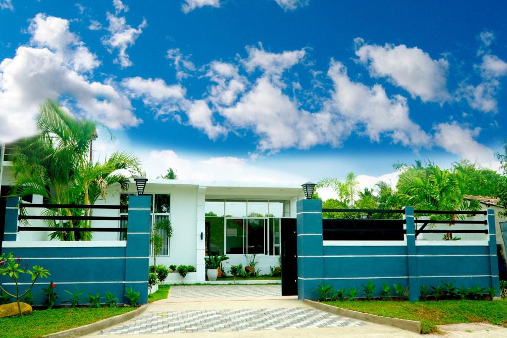 a house with a blue and white facade at Airport 4 Season Transit Hotel in Katunayake
