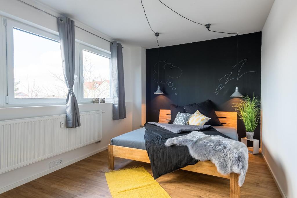 a bedroom with a bed and a black wall at Romantische Wohnung in Bad Wörishofen in Bad Wörishofen