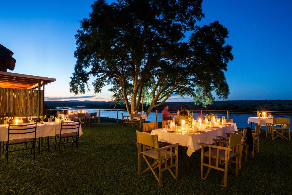 a group of tables and chairs with lights on them at Buhala Lodge in Malelane