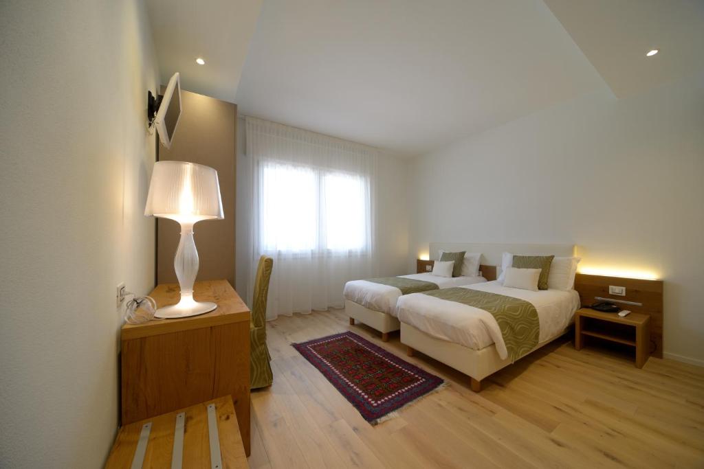 Postel nebo postele na pokoji v ubytování Hotel Ristorante Da Tullio