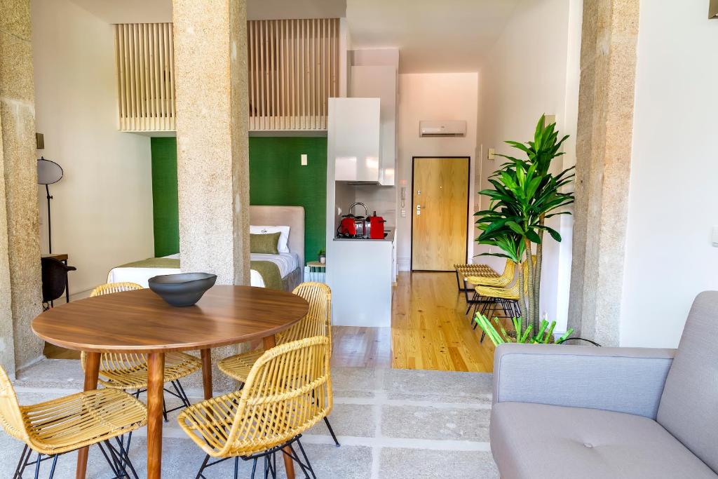 a dining room and living room with a table and chairs at Formosa 178 by Guestify in Porto