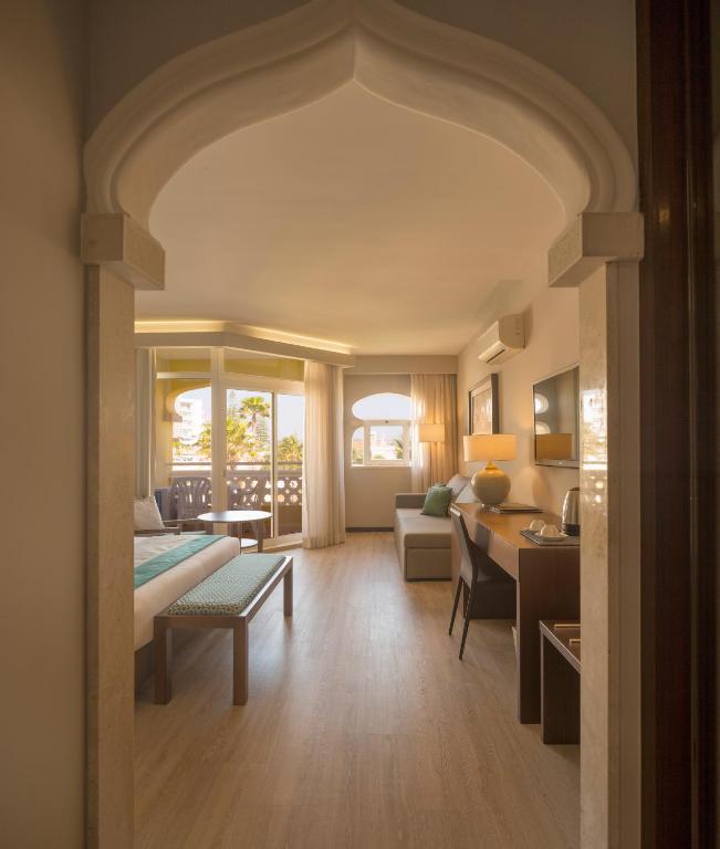 a living room with a bed and a table at AP Oriental Beach - Adults Friendly in Portimão