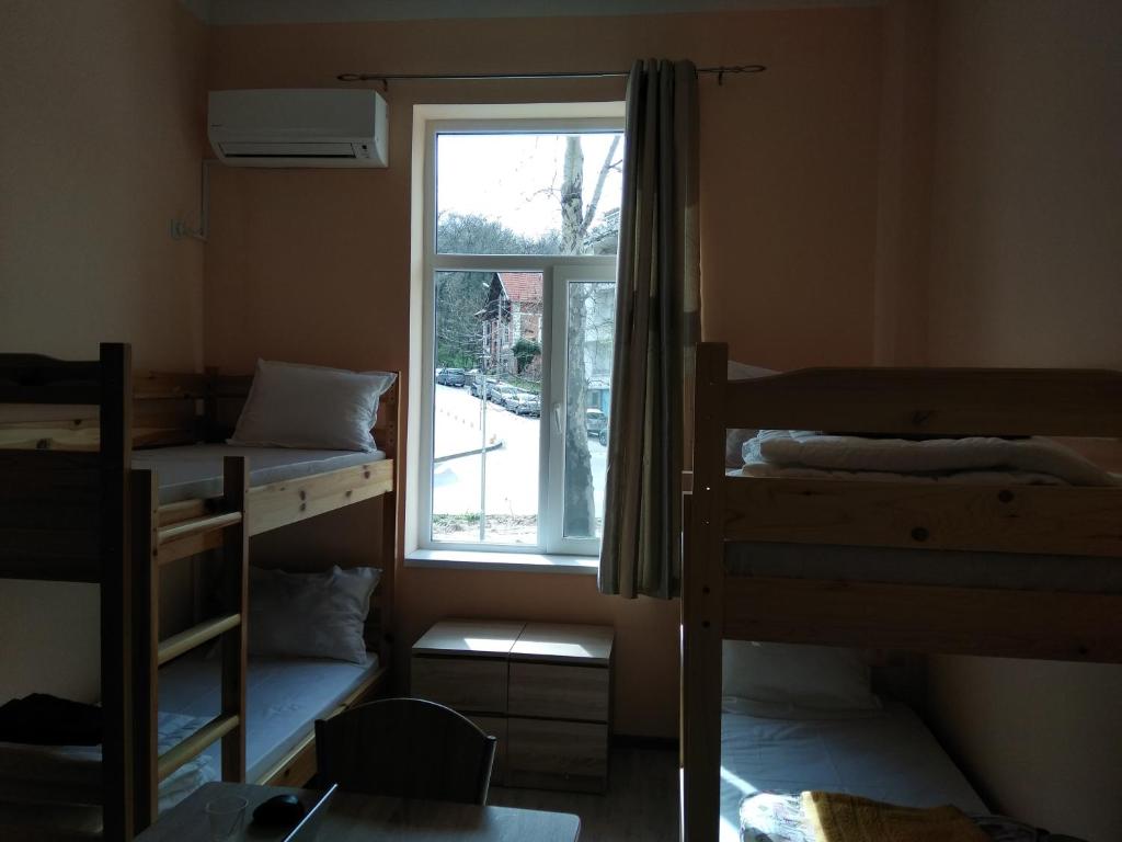 a room with three bunk beds and a window at Hostel Ginger House in Plovdiv