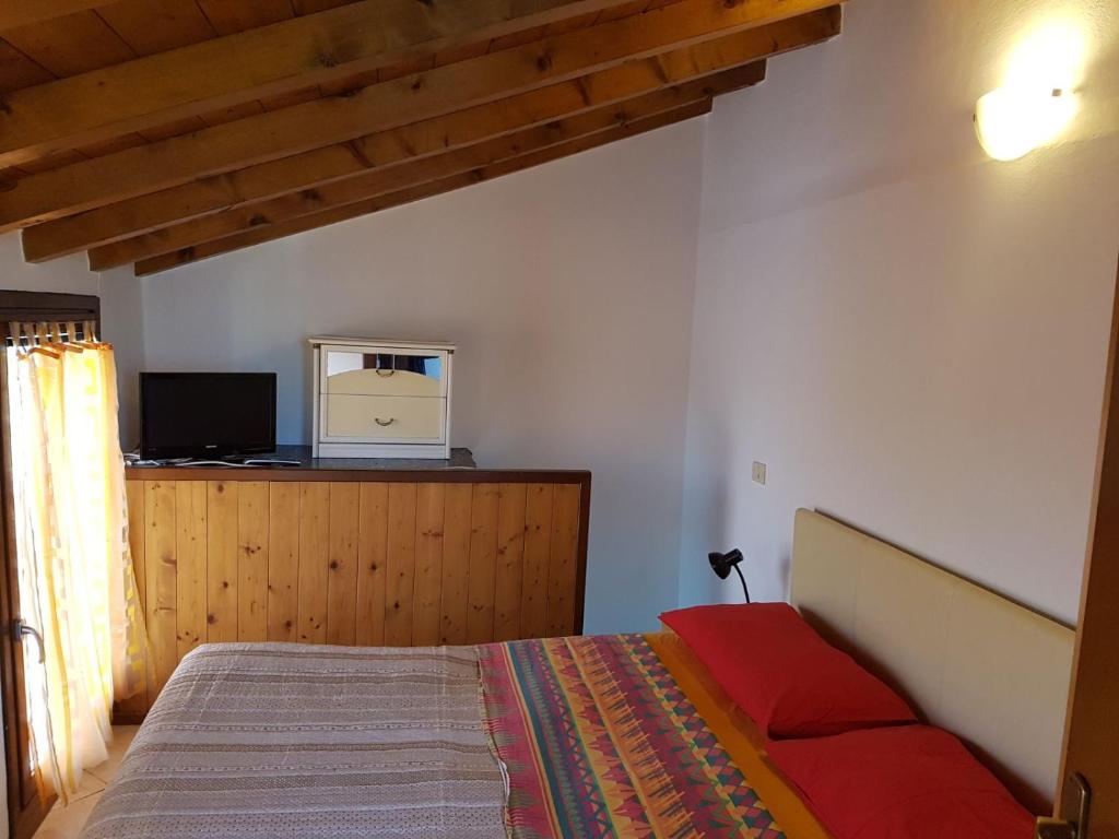 a bedroom with a bed and a television on a cabinet at San polo house in Parma