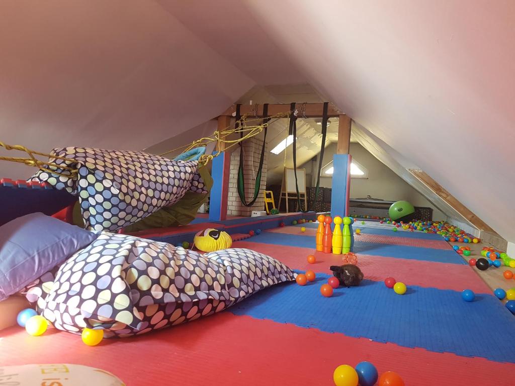 a attic room with pillows and toys on the floor at Vila na Skalce in Česká Kamenice