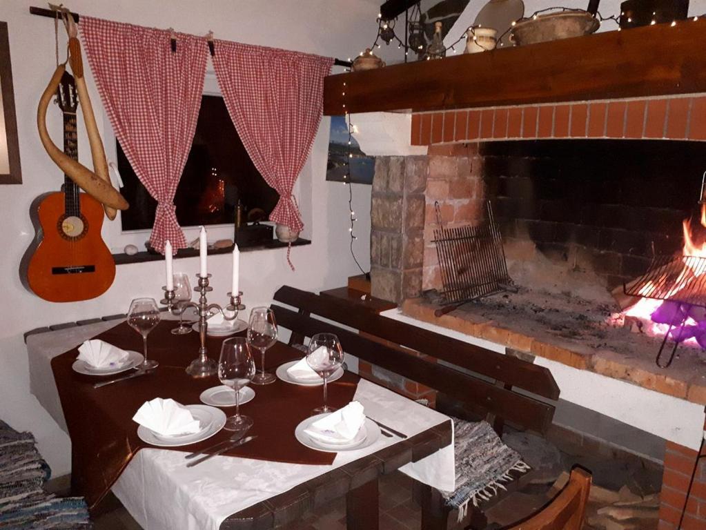 a dining room with a table and a fireplace at Apartment Loza in Slunj